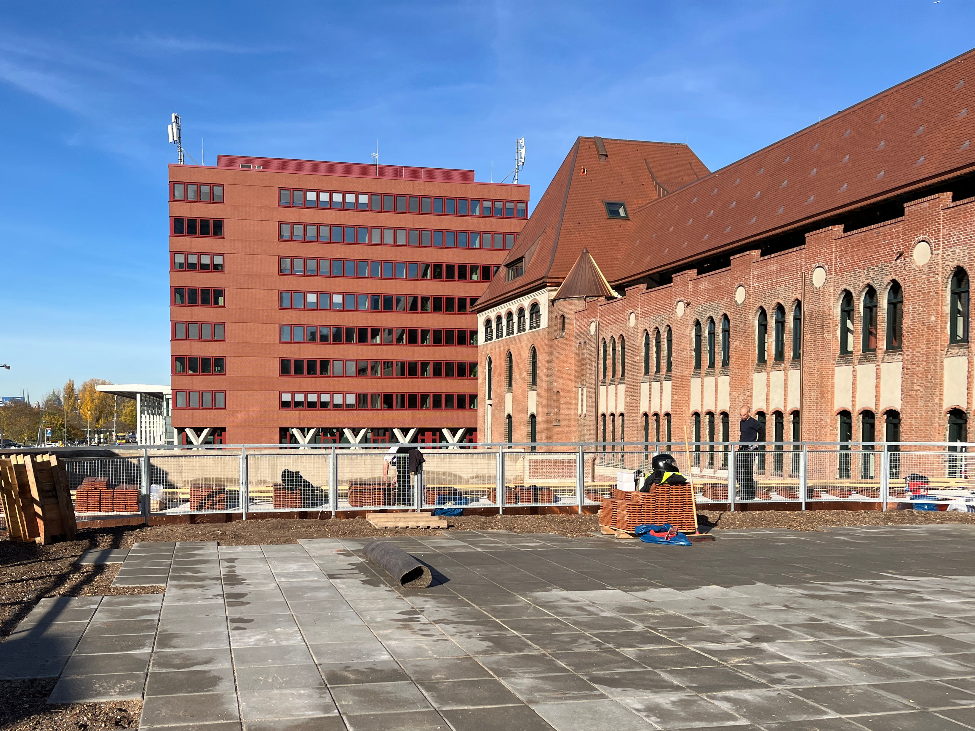 Exterior view of construction progress at the Postbahnhof Berlin with a view of the roof terrace under construction.