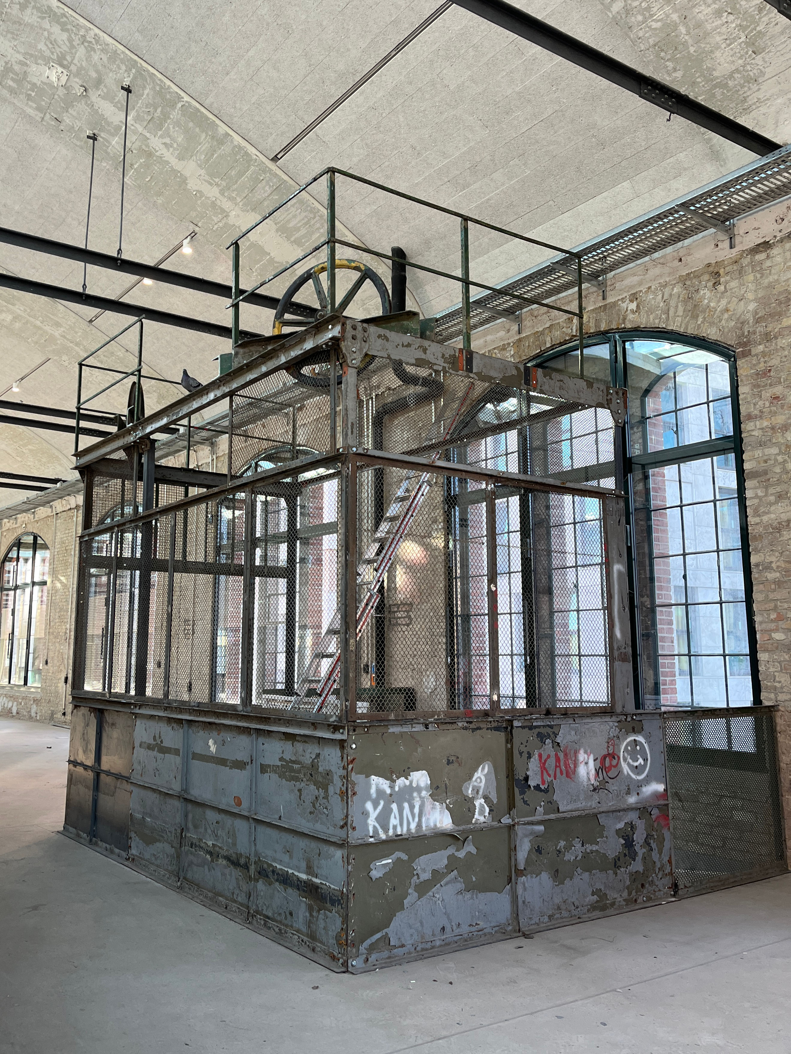 Interior view of construction progress at the Postbahnhof Berlin with a view of the historic emergency staircase inside.