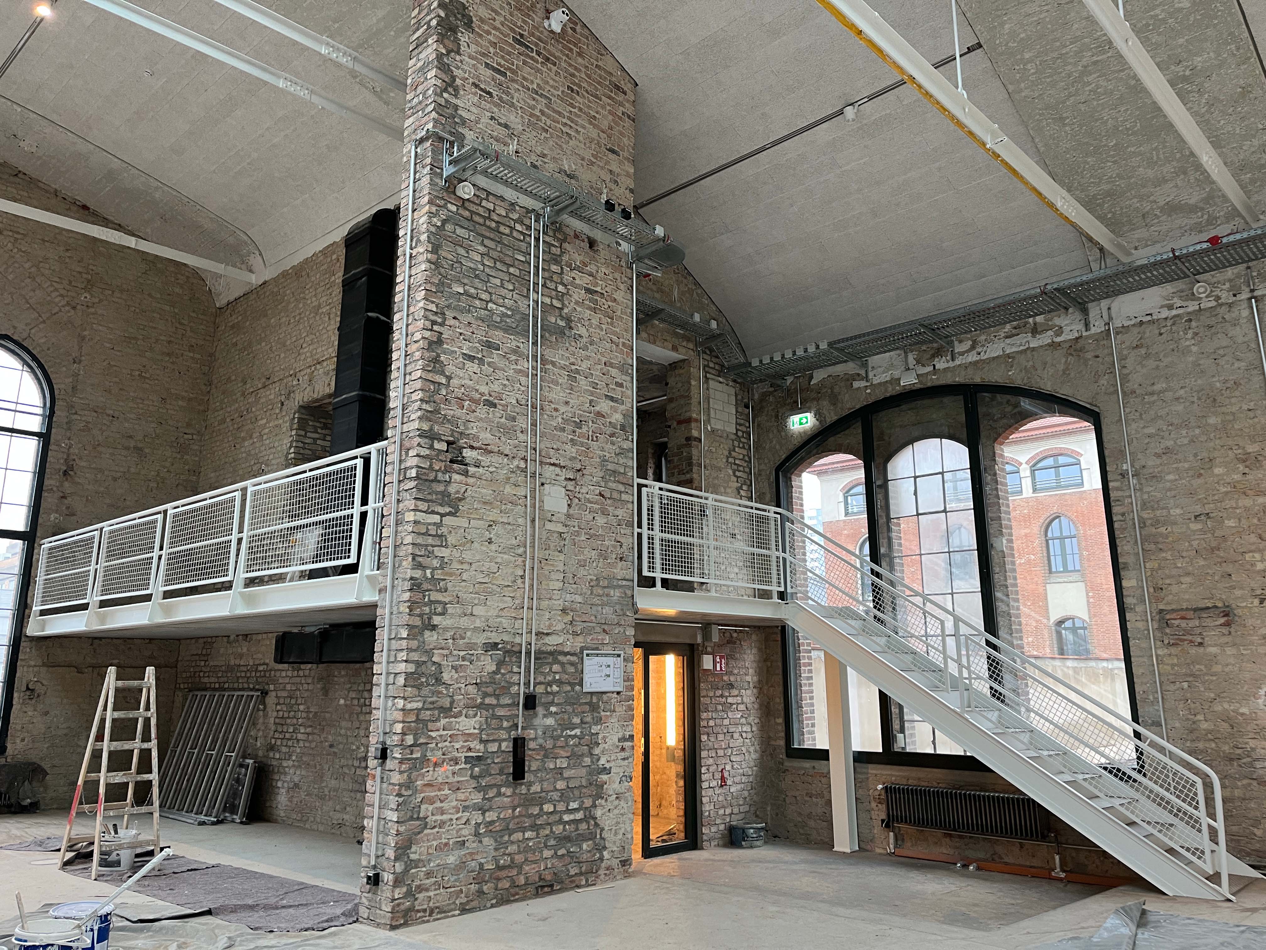 Entrance packing room with supports, open wall areas, and view of window facade.